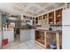 Image shows an unfinished kitchen with empty cabinets and white tile flooring at 4020 Amber Rd, Valrico, FL 33594