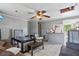 View of a living room with tile floors, gray walls, and a ceiling fan with a light fixture at 4020 Amber Rd, Valrico, FL 33594
