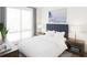 Bright bedroom featuring a plush bed, side tables, and a large window with natural light at 600 3Rd S Ave # 210, St Petersburg, FL 33701