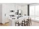 Modern kitchen with stainless steel appliances, white cabinetry, and a spacious island with bar seating at 600 3Rd S Ave # 210, St Petersburg, FL 33701