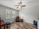 Cozy room with a ceiling fan, wood-look flooring, and window with shutter blinds at 858 Vino Verde Cir, Brandon, FL 33511