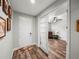 Bright foyer with wood-look floors, leading into an office with glass-panelled doors at 858 Vino Verde Cir, Brandon, FL 33511