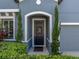 Close-up of front door framed by manicured greenery and an arched entryway at 858 Vino Verde Cir, Brandon, FL 33511