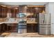 Close-up of the kitchen, featuring dark cabinets and stainless steel appliances at 858 Vino Verde Cir, Brandon, FL 33511