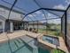 A sparkling pool with spa, brick pavers, and serene landscaping under a screened enclosure at 858 Vino Verde Cir, Brandon, FL 33511