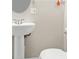 Bathroom features a bright white pedestal sink and toilet at 9315 N 19Th St, Tampa, FL 33612