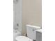Bathroom boasts a bright white toilet and white marbled shower surround with a modern shower head at 9315 N 19Th St, Tampa, FL 33612