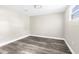 Bright bedroom features neutral walls, base trim and gray, wood-look vinyl floors, and a modern ceiling light at 9315 N 19Th St, Tampa, FL 33612
