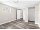 Light and airy bedroom features neutral walls, base trim and gray, wood-look vinyl floors, and a closet at 9315 N 19Th St, Tampa, FL 33612