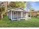 Charming home boasts a welcoming covered porch and meticulously maintained lawn at 9315 N 19Th St, Tampa, FL 33612