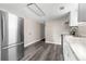 Bright kitchen with stainless steel appliances, white cabinets and vinyl flooring at 9315 N 19Th St, Tampa, FL 33612