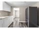 Bright kitchen featuring white cabinets, countertops and stainless steel refrigerator at 9315 N 19Th St, Tampa, FL 33612