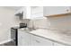 Clean white kitchen with stainless sink and modern appliances at 9315 N 19Th St, Tampa, FL 33612