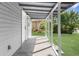 Covered porch extends along the home's exterior, offering shade and outdoor space at 9315 N 19Th St, Tampa, FL 33612