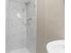 Shower boasts a white marbled shower surround with a modern shower head and chrome fixtures at 9315 N 19Th St, Tampa, FL 33612