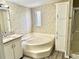 Bathroom featuring a soaking tub and storage cabinets, plus a granite vanity at 9790 66Th N St # 321, Pinellas Park, FL 33782