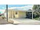 Charming home exterior featuring a covered carport, well-maintained landscaping, and a welcoming entrance at 9790 66Th N St # 321, Pinellas Park, FL 33782