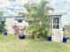 Cozy home with a well-manicured lawn, complete with vibrant plants and a screened patio at 9790 66Th N St # 321, Pinellas Park, FL 33782