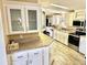 Bright kitchen featuring white cabinets, stainless steel appliances and granite countertops at 9790 66Th N St # 321, Pinellas Park, FL 33782