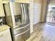 Stainless steel refrigerator in kitchen with ample counterspace and wood look flooring at 9790 66Th N St # 321, Pinellas Park, FL 33782
