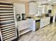Open kitchen featuring modern appliances, granite countertops, and wood-look floors at 9790 66Th N St # 321, Pinellas Park, FL 33782