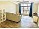 Bright living room featuring tiled floors, a large window and neutral furnishings at 9790 66Th N St # 321, Pinellas Park, FL 33782