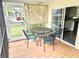 Relaxing screened porch featuring a dining table and comfortable chairs at 9790 66Th N St # 321, Pinellas Park, FL 33782