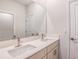 Bathroom featuring double sinks, quartz countertops and a glass enclosed shower in background at 10225 Fieldstone Myrtle Way, San Antonio, FL 33576