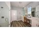Bright bathroom features white cabinets, modern shower and a full vanity with stylish fixtures at 10267 Fieldstone Myrtle Way, San Antonio, FL 33576