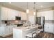 Stylish kitchen with white cabinets, stainless steel appliances, and a functional island with bar seating at 10267 Fieldstone Myrtle Way, San Antonio, FL 33576