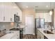 Modern kitchen with white cabinets, stainless steel appliances, and sleek countertops at 10267 Fieldstone Myrtle Way, San Antonio, FL 33576