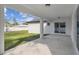 Covered patio showcasing a clean, modern design with a concrete floor, perfect for outdoor entertaining at 104 1St Ne Ave, Lutz, FL 33549