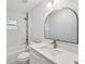 Bright bathroom featuring a modern vanity with a white countertop and a bathtub with tiled walls at 104 1St Ne Ave, Lutz, FL 33549
