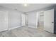 Bright bedroom with wood-look flooring, neutral walls, closet and multiple doorways for flexible living at 104 1St Ne Ave, Lutz, FL 33549
