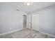 Bedroom with tile flooring, standard closets and a view to connecting rooms at 104 1St Ne Ave, Lutz, FL 33549