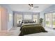 Spacious bedroom featuring a comfortable bed, sliding glass doors, and a serene atmosphere at 104 1St Ne Ave, Lutz, FL 33549