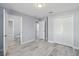 Spacious bedroom with multiple doorways and closets, featuring stylish gray flooring and neutral walls at 104 1St Ne Ave, Lutz, FL 33549