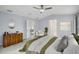 Cozy bedroom features a comfortable bed, dresser, and access to the dining room at 104 1St Ne Ave, Lutz, FL 33549