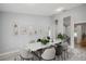 Dining room with a stylish marble table, decorative wall art and chairs for Gathering gatherings at 104 1St Ne Ave, Lutz, FL 33549