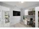 Cozy office space with a modern desk, shelving, and view to dining room area at 104 1St Ne Ave, Lutz, FL 33549