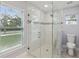 Modern glass enclosed shower stall with mosaic tile accents and plenty of natural light at 104 1St Ne Ave, Lutz, FL 33549