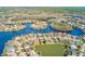 Expansive aerial view of waterfront community with houses surrounding a lake and islands at 10708 Cory Lake Dr, Tampa, FL 33647