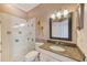 Stylish bathroom features a glass-enclosed shower, granite countertop, and elegant lighting at 10708 Cory Lake Dr, Tampa, FL 33647