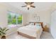 Cozy bedroom with a ceiling fan and views of the backyard at 10708 Cory Lake Dr, Tampa, FL 33647