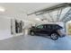 Spacious garage with epoxy floors, car and plenty of storage space at 10708 Cory Lake Dr, Tampa, FL 33647
