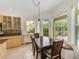 Breakfast nook adjacent to kitchen with wooden table and large windows offering a view of the pool at 10708 Cory Lake Dr, Tampa, FL 33647
