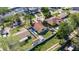 Aerial view of a home with a well-maintained yard, shed, and privacy fence at 10719 Drummond Rd, Tampa, FL 33615