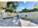 Cozy tiled back patio with lounge chairs and a privacy fence, perfect for outdoor relaxation at 10719 Drummond Rd, Tampa, FL 33615
