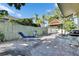 Relaxing tiled back patio featuring lounge chairs, a grill, and a shaded hammock area at 10719 Drummond Rd, Tampa, FL 33615