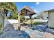 Backyard oasis featuring a hammock, rock garden, and tiled area at 10719 Drummond Rd, Tampa, FL 33615